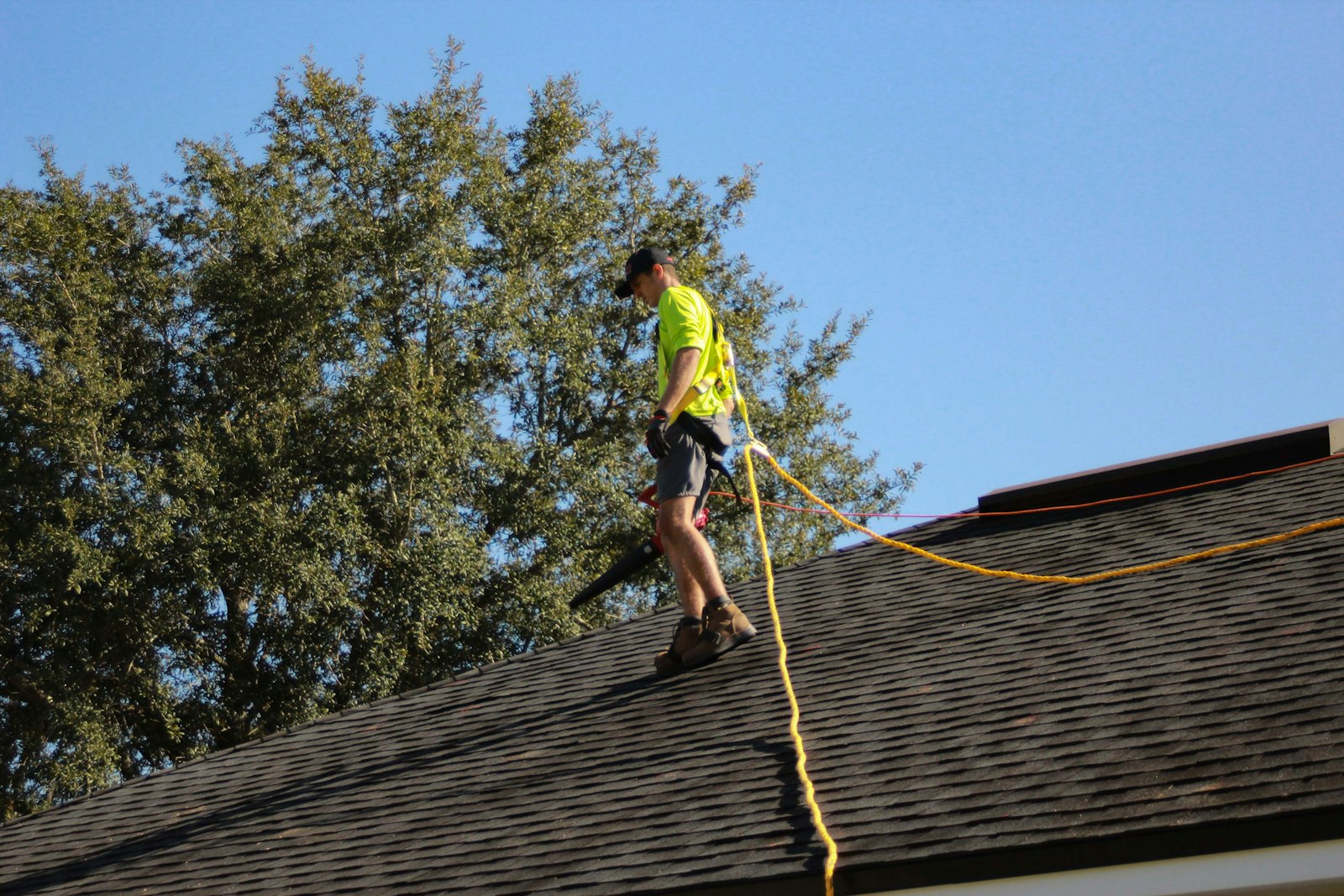 Roofer in hi-vis working on a pitched roof.