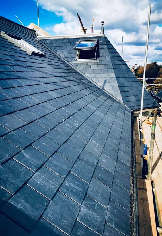 Finished pitched slate roof with new rooflights by SRB Services.