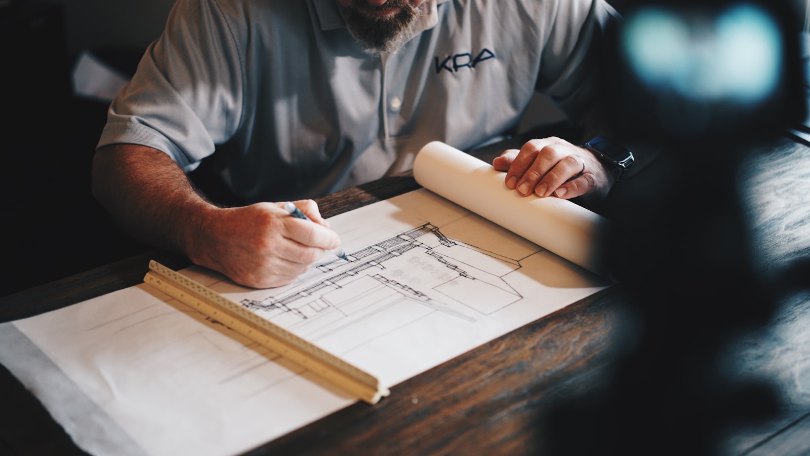 Contractor working through building drawings.