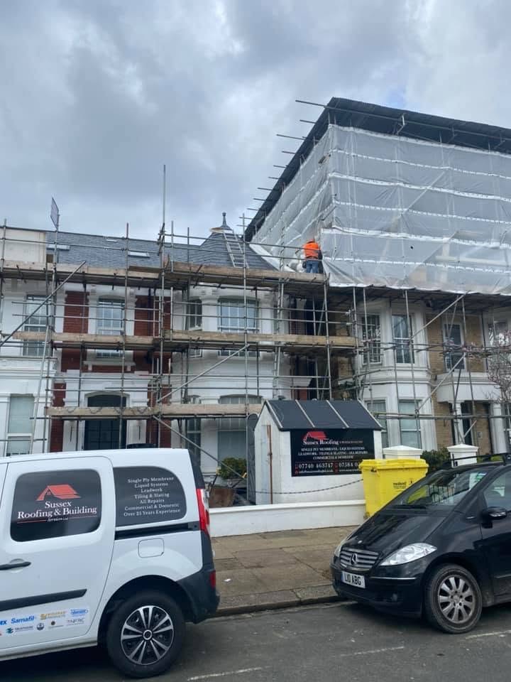 SRB branded van and enclosed scaffold on a live terrace reroof.
